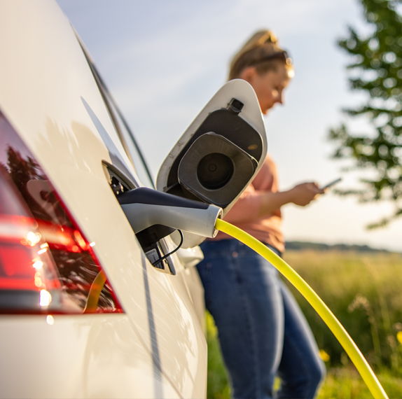 woman charging electrical car