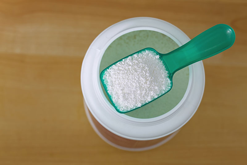 Washing powder on a scoop