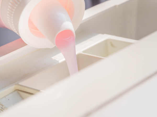 Pouring liquid into a washing machine