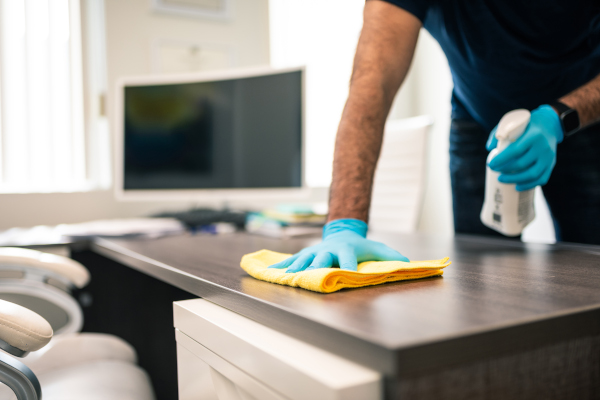 A man cleaning an office desk