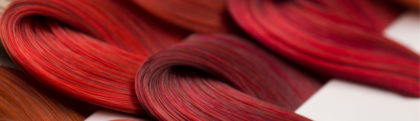 Red coloured hair folded in locks