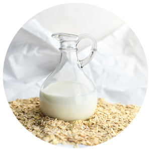 Jug of oat milk on a pile of oats