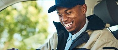 transportation driver smiling inside his vehicle